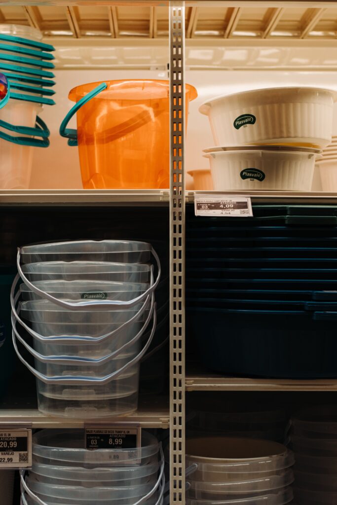 Stackable storage bins organizing cleaning supplies under a kitchen sink
