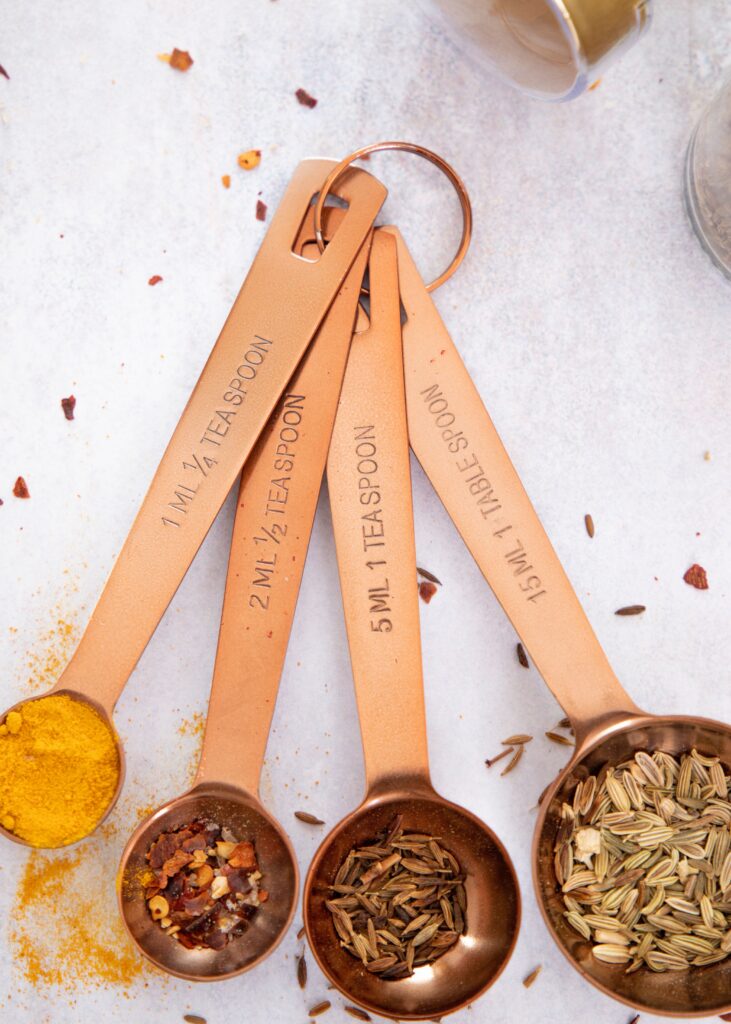Set of measuring spoons with spice amounts engraved, connected on a ring