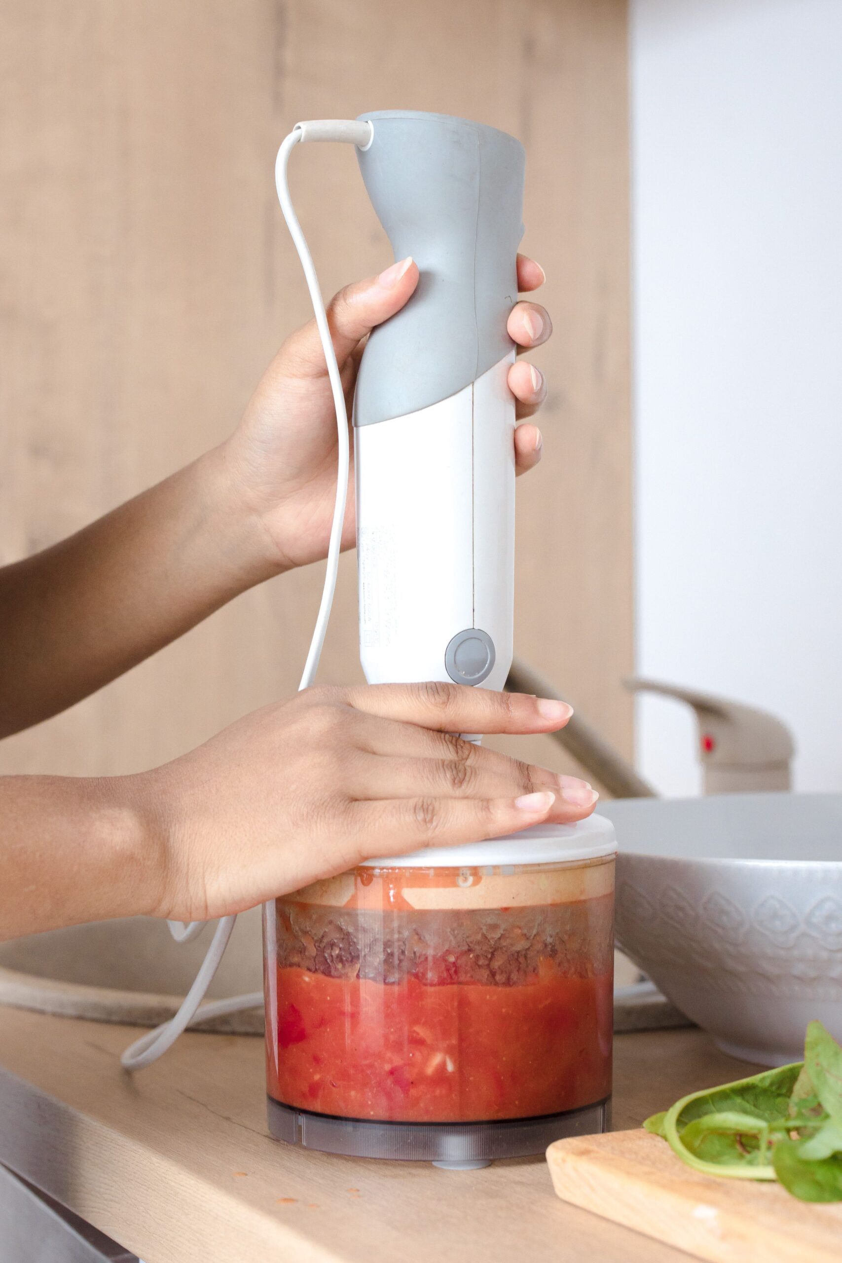 Using a compact immersion blender to prepare sauce in a small kitchen